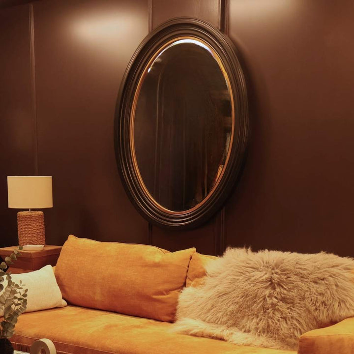large black and gold oval mirror