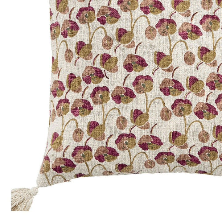cushion with floral pattern on natural coloured fabric with tassels