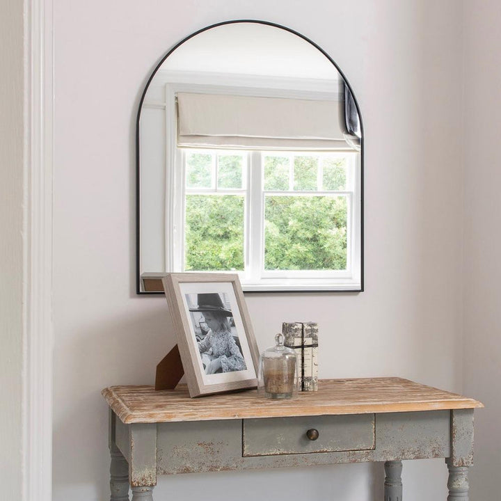 iron framed arched mirror